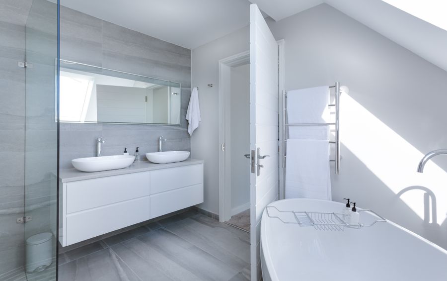 Modern fitted bathroom with twin basins and freestanding bath